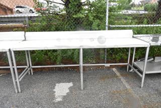 Universal stainless steel cutting board table with under shelf, gently used condition, sturdy construction, outdoor setting.