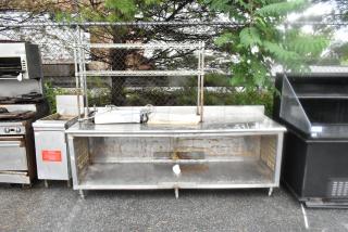 Stainless steel table with under shelf and two-tier over shelf, used condition. Contents not included. Ideal for commercial use.
