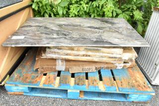 Stack of new scratch and dent items on a blue pallet, including a 600PTS2436 stainless steel shelf, wrapped in cardboard.