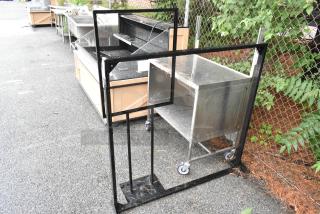 2 black metal items: a rectangular frame and a sign frame. Both structures are sturdy with visible wear.