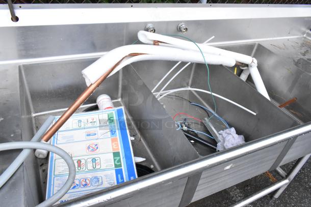 Winholt stainless steel 3-bay sink with dual drain boards and Insinkerator garbage disposal. Pipes and wires included.