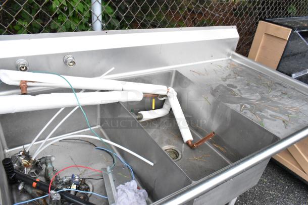Winholt stainless steel commercial 3 bay sink with dual drain boards, includes Insinkerator garbage disposal; some visible wear.