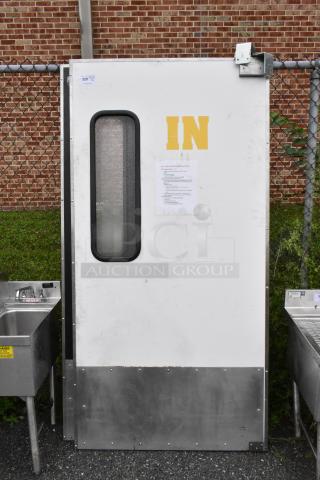 Two Chase metal swinging kitchen doors with windows, IN label, and metal kick plate. Auction item shows moderate wear.
