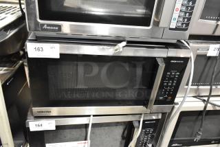 Toshiba metal countertop microwave oven with plate, 120 volts, 1 phase, in good condition, with visible control panel.