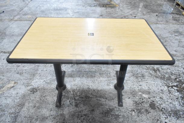 Dining height table with wood top and metal base, featuring black edging. Offers a solid, durable construction.