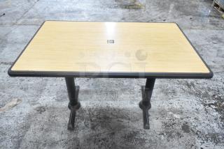 Dining height table with wood top and metal base, featuring black edging. Offers a solid, durable construction.
