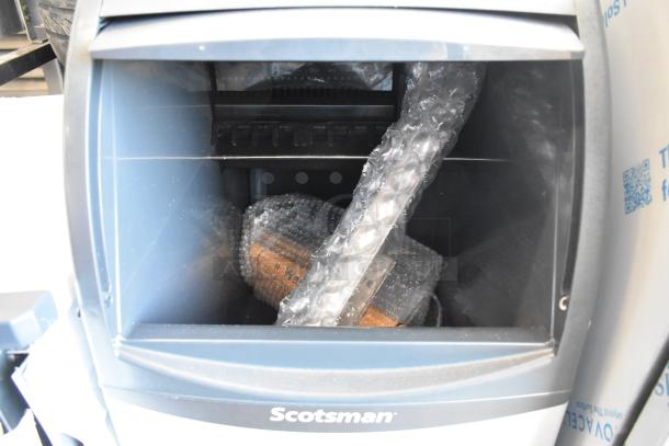 New Scotsman CU0715MA-1A stainless steel undercounter ice machine. Bubble wrap inside; capacity 80 lb, 115V, 1 Phase.
