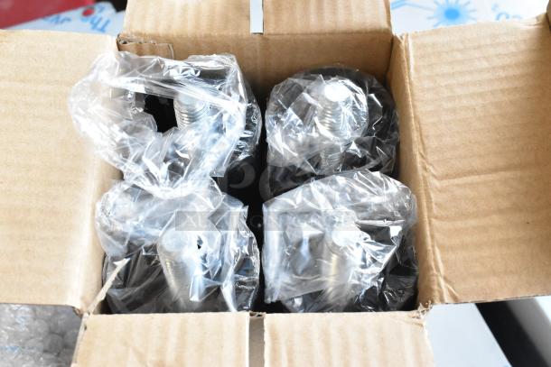 Cardboard box containing screws wrapped in clear plastic, part of Scotsman CU0715MA-1A ice machine shipment.