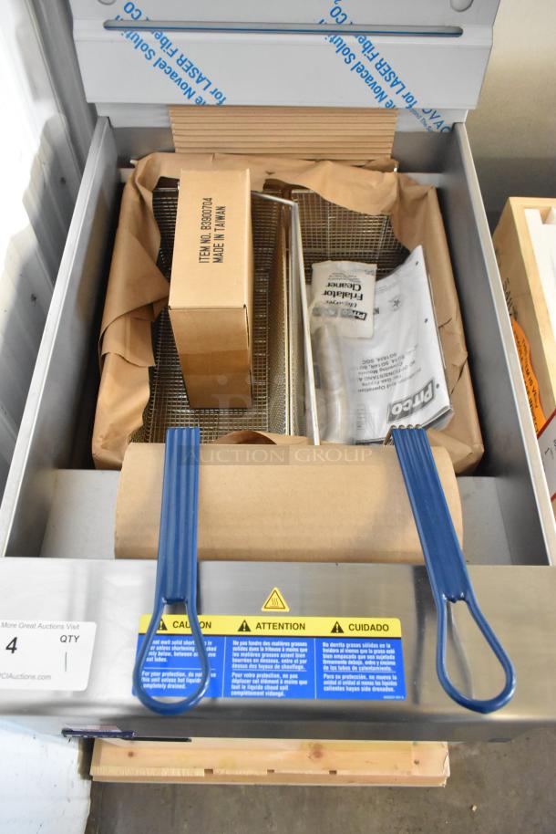 Brand new 2025 Pitco Frialator SG18 natural gas fryer, 75 lb capacity, 140,000 BTU, with two metal baskets, in box.