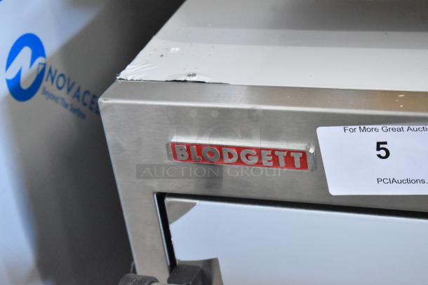 Brand new Blodgett 1415 stainless steel countertop oven, electric, 208V, 3 Phase, with dented corner. Auction tag visible.