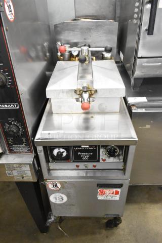 Henny Penny 600 stainless steel pressure fryer, natural gas, 80,000 BTU, on casters. Visible controls, labels; used condition.