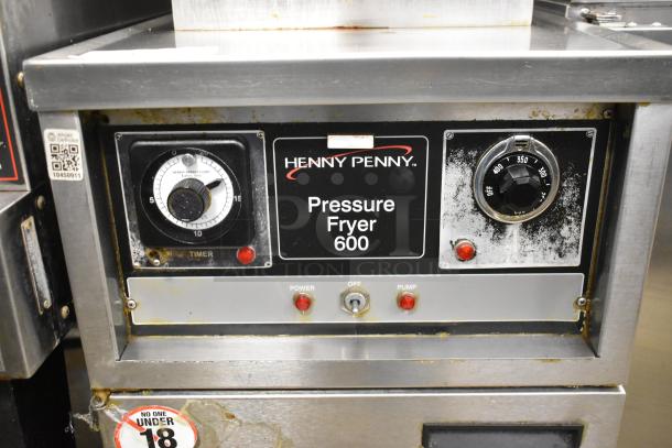 Henny Penny 600 stainless steel pressure fryer, natural gas-powered, on commercial casters, 80,000 BTU, control panel visible.