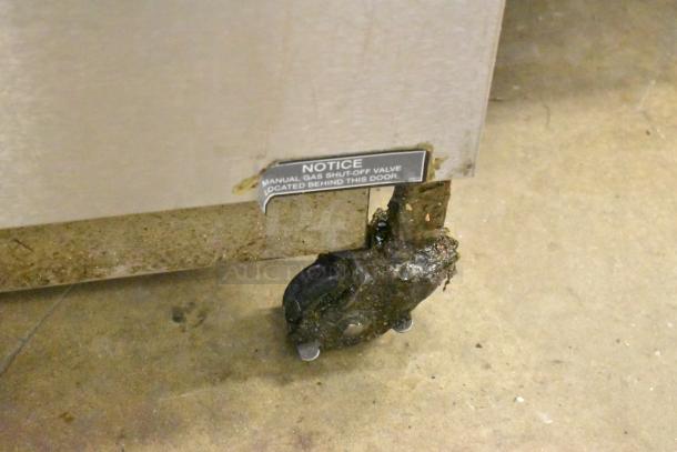 Henny Penny 600 pressure fryer on casters, stainless steel, 80,000 BTU; label indicates manual gas shut-off valve location.