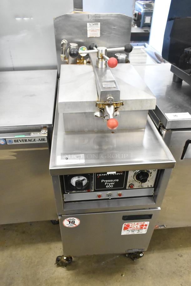 Henny Penny 600 stainless steel pressure fryer on casters, natural gas, 80,000 BTU. Front dial, labels visible. Good condition.