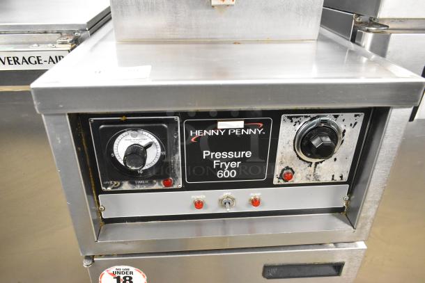 Henny Penny 600 stainless steel commercial pressure fryer, natural gas, 80,000 BTU, on casters, visible control panel.