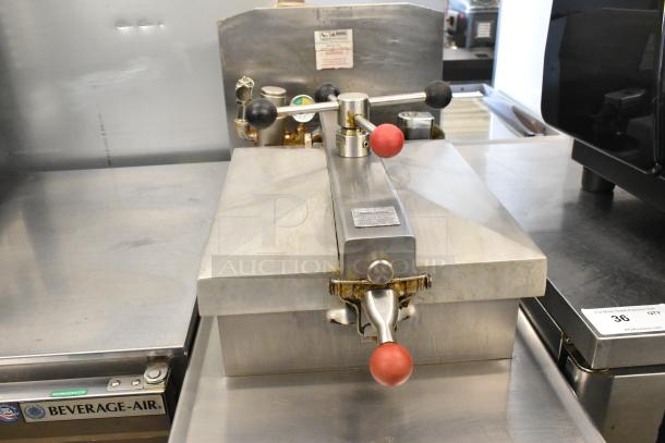 Henny Penny 600 stainless steel commercial pressure fryer, natural gas powered, on casters, 80,000 BTU, used condition.