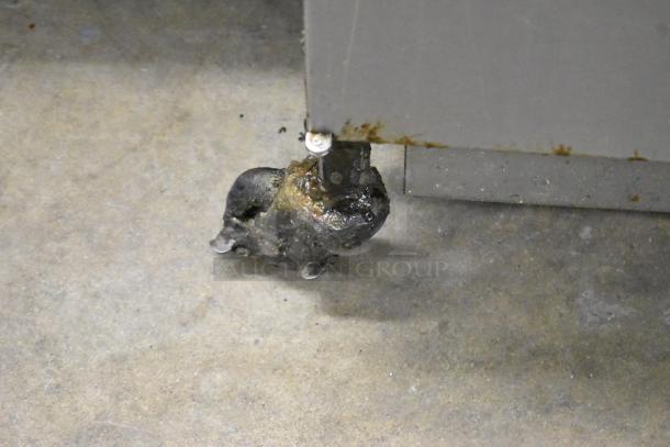 Henny Penny 600 stainless steel pressure fryer on casters, natural gas, 80,000 BTU, visible caster shows wear.
