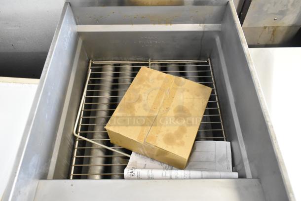 Brand new Pitco Frialator SG18 deep fat fryer, stainless steel, propane gas, 140,000 BTU, with commercial casters, slight dents.