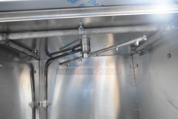 Stainless interior of Noble Wareforce UH30-E dishwasher showing spray arms and piping, highlighting commercial quality.