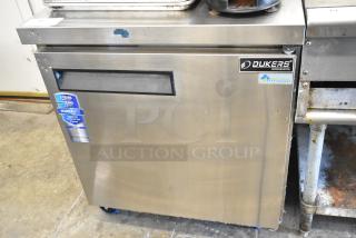 Dukers DUC29R stainless steel undercounter cooler, single door, commercial casters, 115V, warranty label visible.