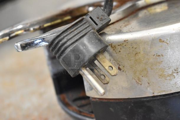 Metal commercial countertop espresso bean grinder, 115 Volts, 1 Phase, with signs of wear on the metal surface.