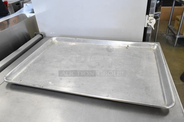 Full-size metal baking pan, slightly used, durable aluminum, ideal for commercial kitchens. Auction includes 42 pans.