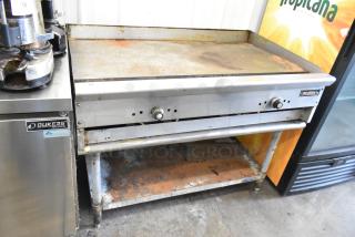 Tri-Star Stainless Steel Commercial Griddle on equipment stand, used condition, visible wear on surface, dual control knobs.