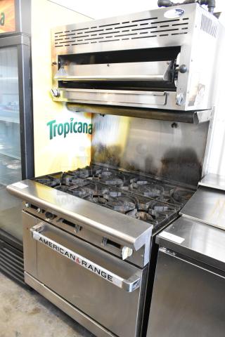 American Range stainless steel 6-burner gas range with salamander cheese melter, backsplash, and oven. Good condition.
