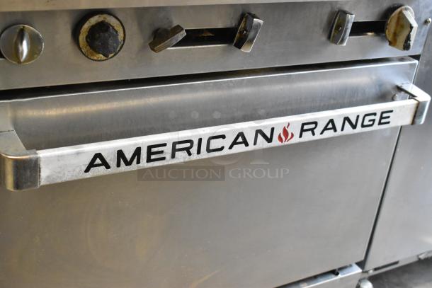American Range stainless steel commercial gas-powered 6-burner range with salamander cheese melter, backsplash, and oven.