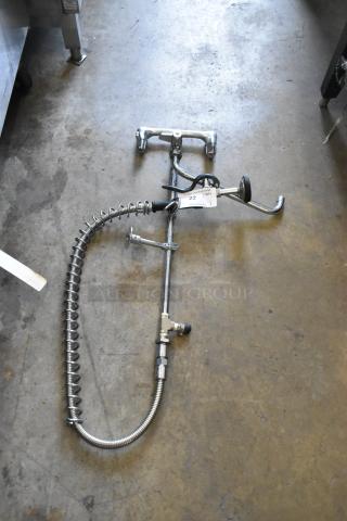 Spray nozzle attachment with faucet, chrome finish, flexible hose, some wear. Tag indicates quantity 22, FC Auctions.