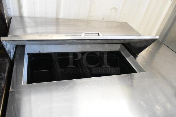 Beverage Air SPE48HC-08 stainless steel commercial sandwich and salad prep table with open top, revealing empty compartments.