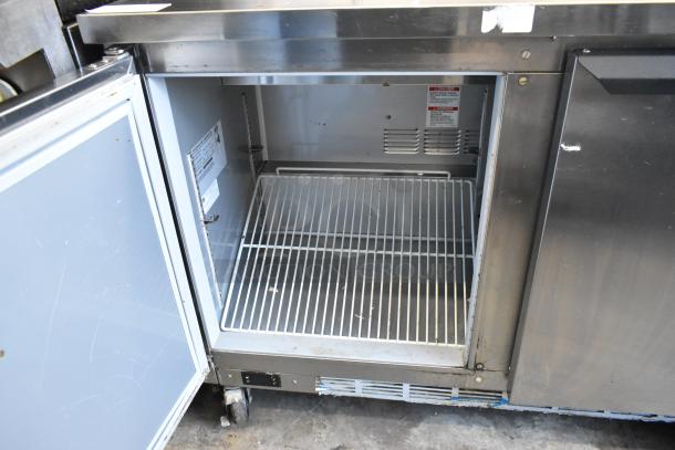 Beverage Air SPE48HC-08 stainless steel prep table, open door showing inside, on commercial casters, 115V, 1 Phase.