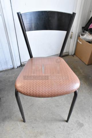 Dining chair with orange/brown cushion, metal frame, slight wear visible. Auction offers seven times the bid.