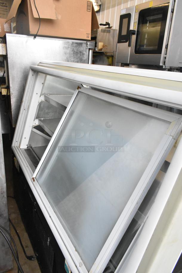 Turbo Air TD-5R metal deli display case, 115 volts, visible shelving, some wear, ideal for commercial use.
