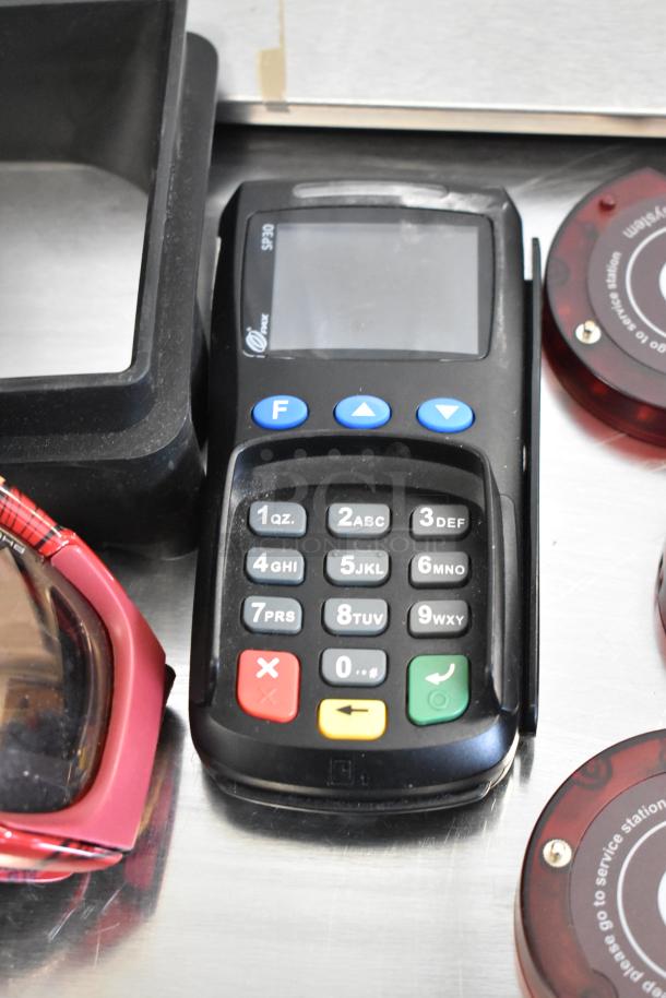 Lot of various items including credit card reader, queuing wireless call system discs; minor wear visible.