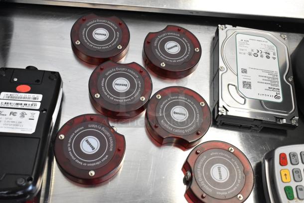 Lot includes 2 credit card readers, 6 queuing discs, and a Seagate hard drive. Items in used condition.