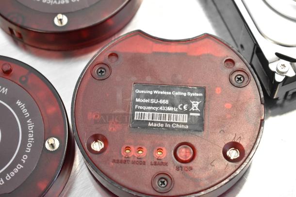 Lot of wireless call system discs, model SU-668, frequency 433MHz, with visible "Made in China" label.
