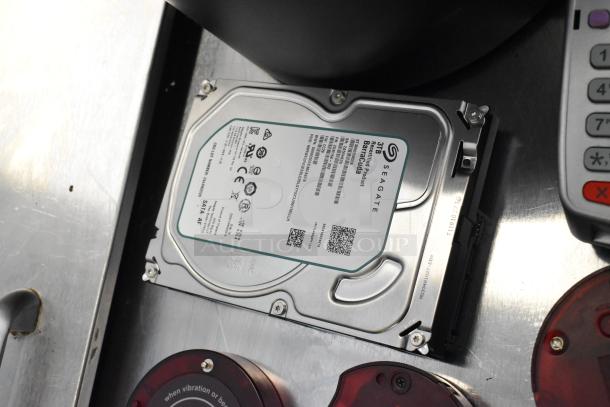 Lot with Seagate 3TB Barracuda hard drive, wireless call system discs, and credit card readers. Good condition.