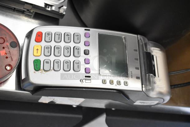 Lot includes a credit card reader model VX520, queuing wireless call system disc, and hard drive. Used condition.