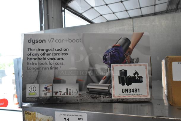 Dyson V7 Car and Boat Handheld Vacuum in original box, features strong suction, extra tools for cars, and long runtime.