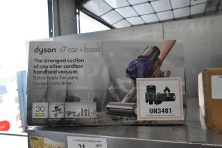 Dyson V7 Car and Boat Handheld Vacuum in original box, features strong suction, extra tools for cars, and long runtime.