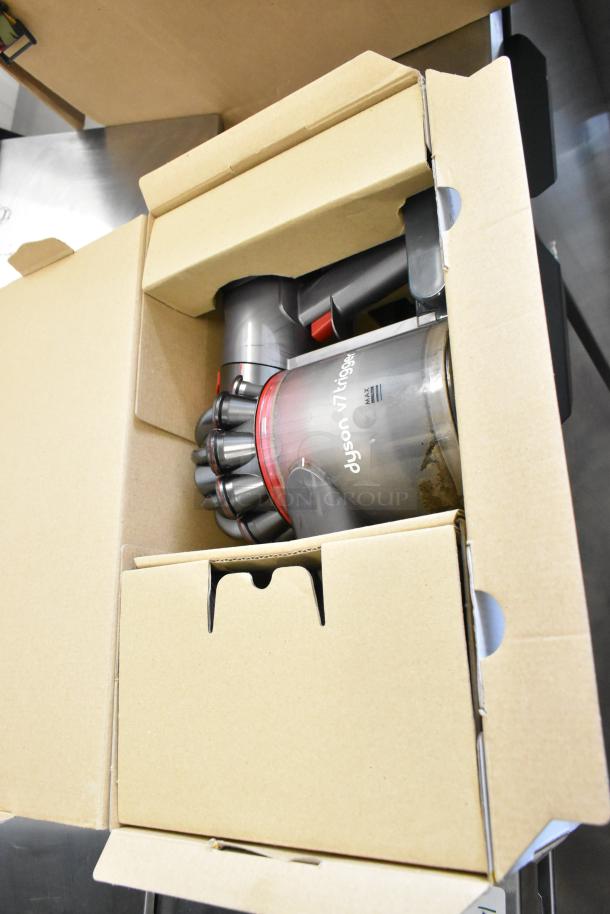 Dyson V7 Car and Boat Hand Vacuum Cleaner in original box, visible branding, appears in like-new condition.