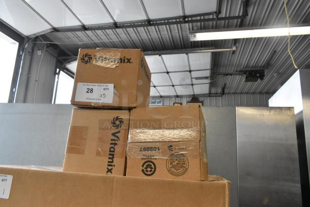 VitaMix transition lids in original boxes, labeled for auction. Box labeled "28 QTY x5." Ideal for collectors or resellers.