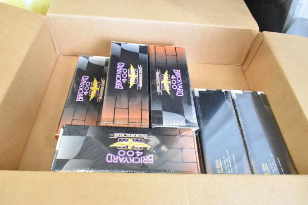 Boxes of Brickyard 400 Inaugural Race 1994 figurines, sealed in original packaging, labeled with race logo and details.