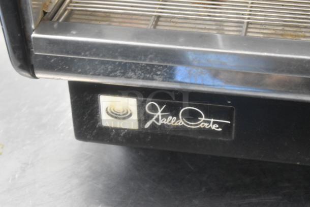 Dalla Corte stainless steel commercial countertop 3 group espresso machine; includes 3 portafilters, 2 steam wands, visible logo.