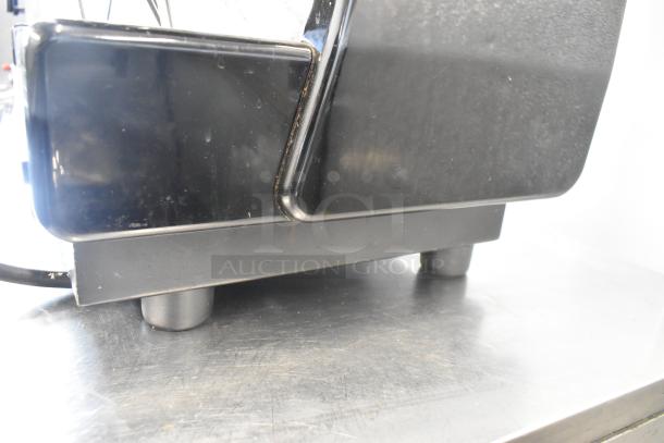 Dalla Corte stainless steel commercial 3 group espresso machine, includes 3 portafilters and 2 steam wands, visible in dense side view.