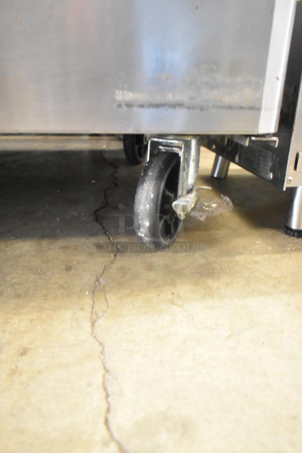 Turbo Air MUR-48 stainless steel undercounter cooler on commercial casters, showing caster wheel detail. 115V, 1 Phase.