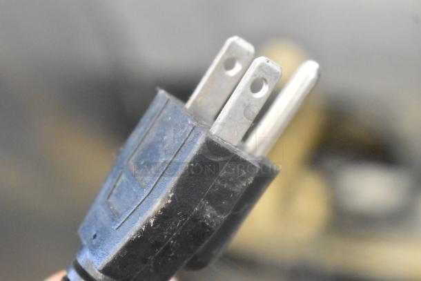 Close-up of a power plug for the Benchmark USA 54012 Stainless Steel Pizza Oven, 120 volts, 1 phase.