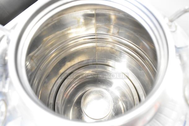Stainless steel metal urn interior, showing smooth, polished surfaces. No visible imperfections or markings.