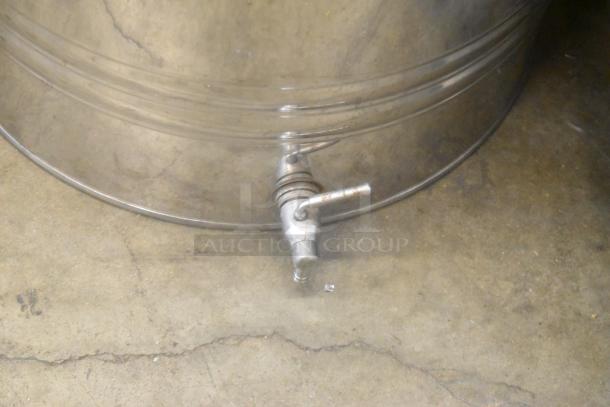 Silver metal urn with a spigot, showing signs of wear. Ideal for beverages. Auction includes two identical urns.